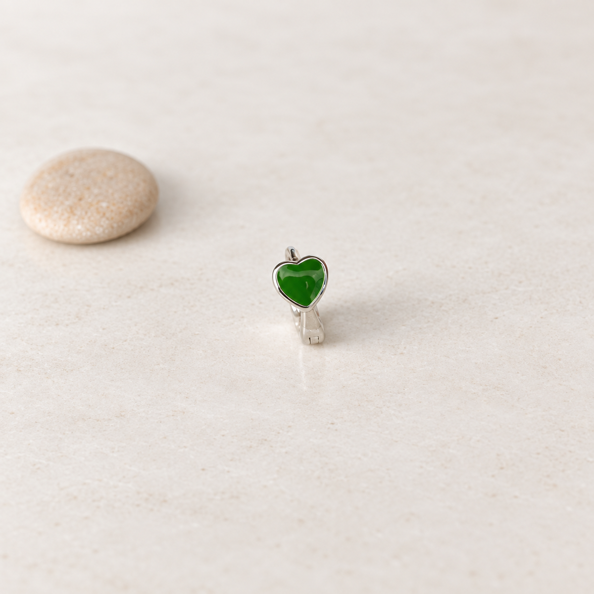 Silver hoop ring with a green heart