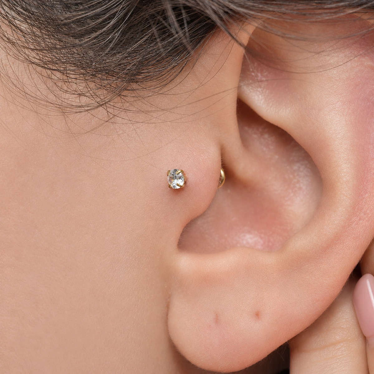 Silver solitaire flat-back piercing stud worn on the tragus — Toku LONDON