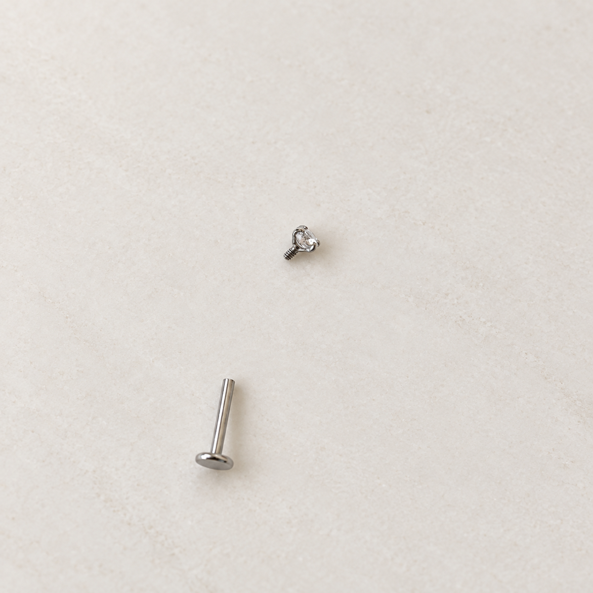 Silver solitaire piercing stud with top removed, showing the post — Toku LONDON