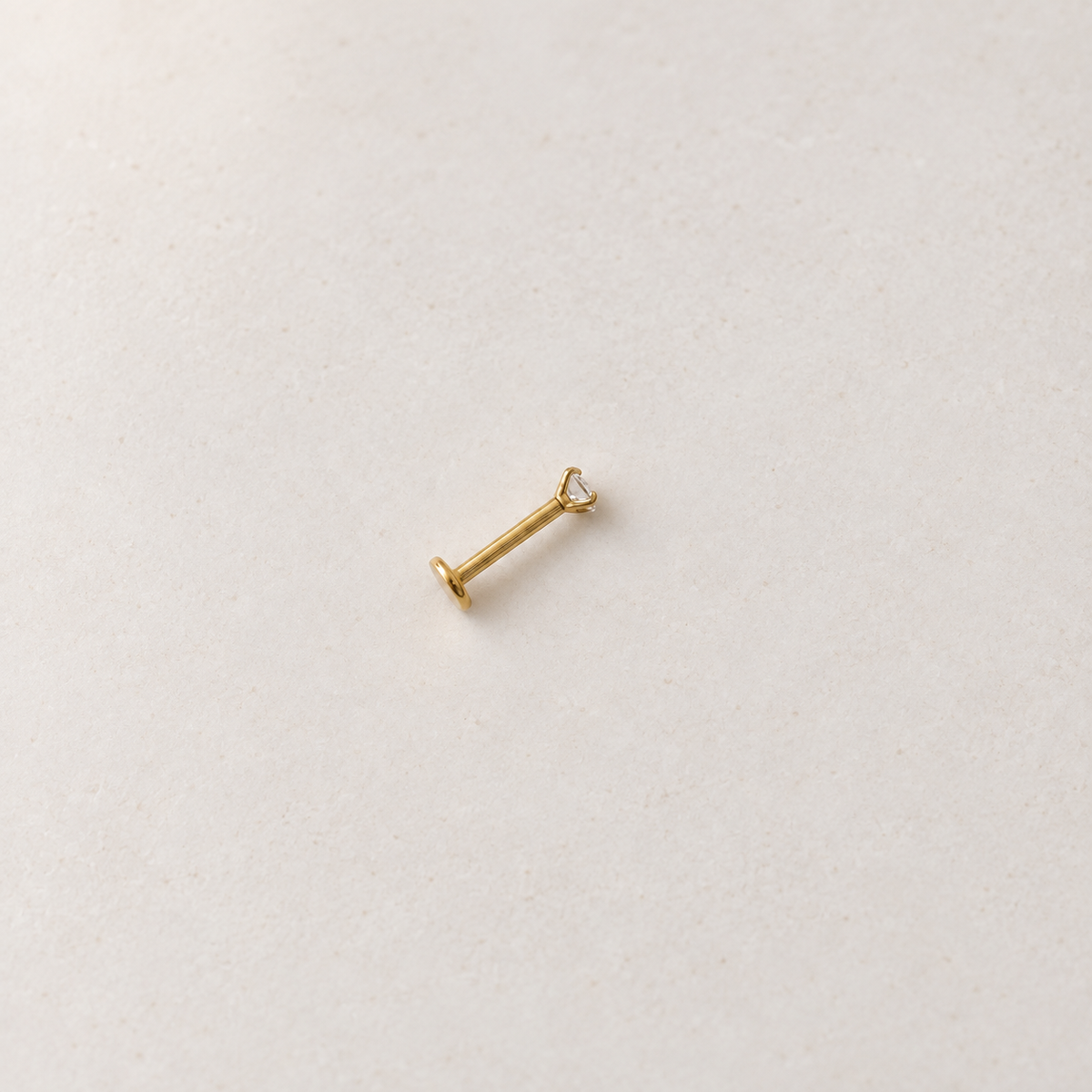 Gold solitaire flat-back piercing stud, product view — Toku LONDON