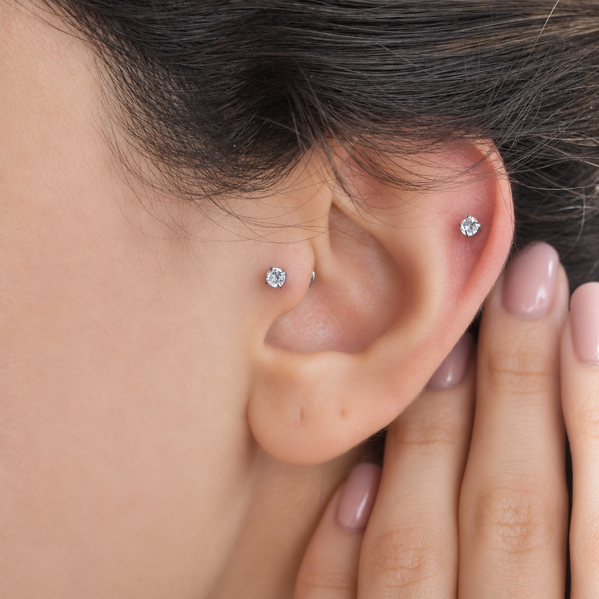 Silver solitaire studs shown worn on the ear — Toku LONDON