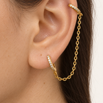 Gold double hoop ear chain earring worn between helix and lobe