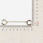 Double hoop ear chain earring beside a ruler for size reference