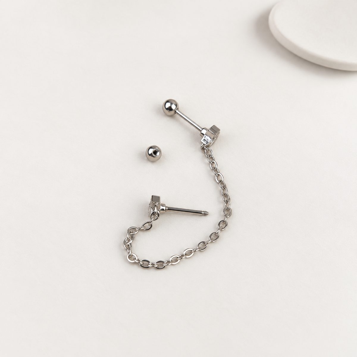 Silver star ear chain earring showing the connecting chain and post backs