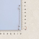 Silver star ear chain earring beside a ruler, size guide