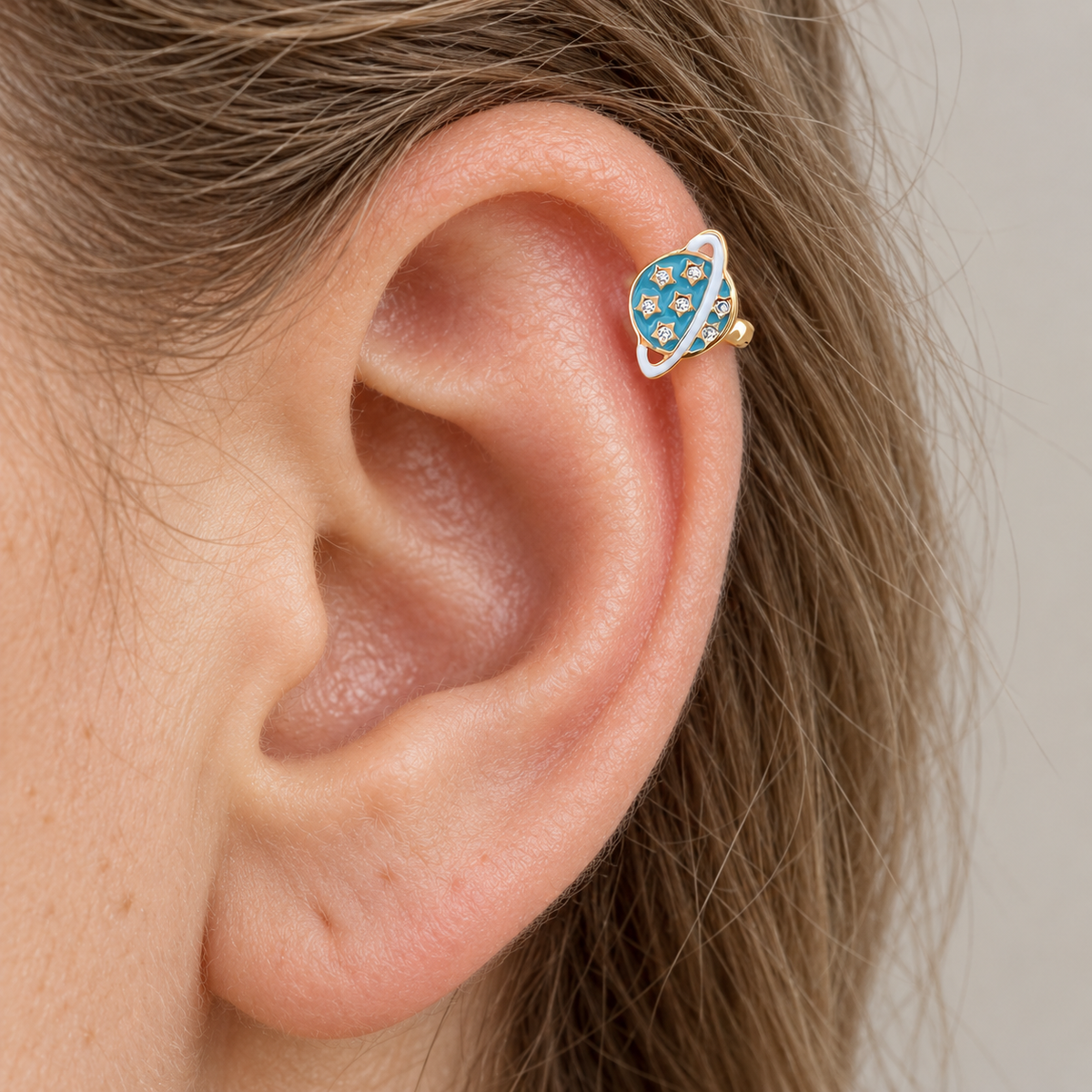 Turquoise blue and gold planet hoop earring worn on the upper ear — Toku LONDON