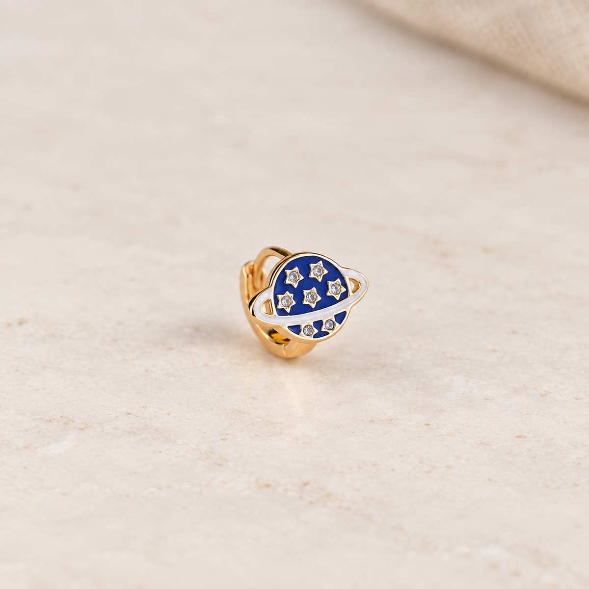 Navy blue planet hoop earring with gold stars, product view — Toku LONDON