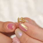 Gold crystal leaf hoop earring close-up