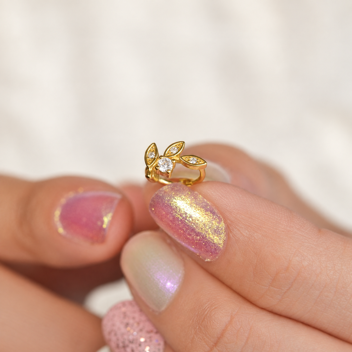 Gold crystal leaf hoop earring close-up