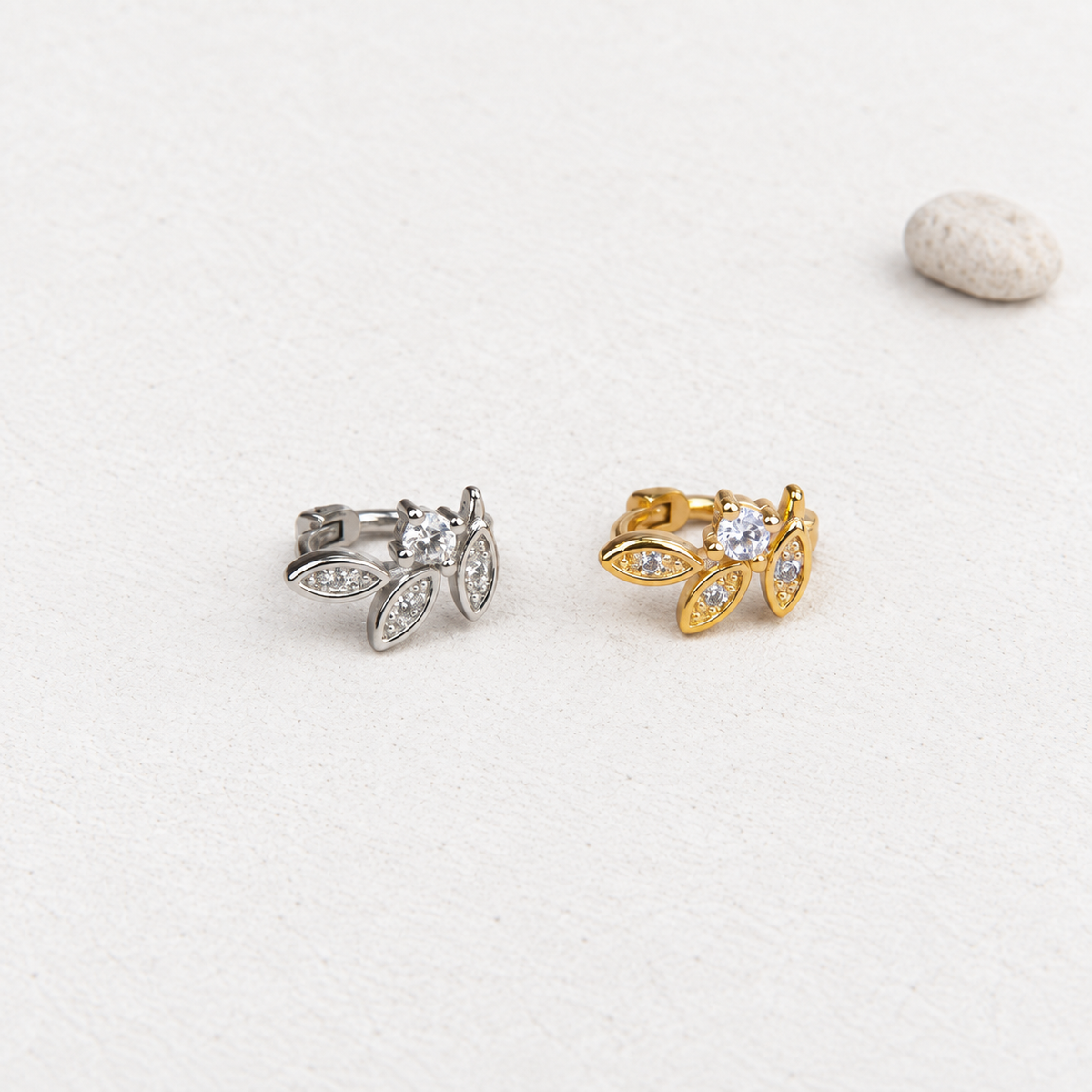 Gold and silver leaf hoop earrings, angled view
