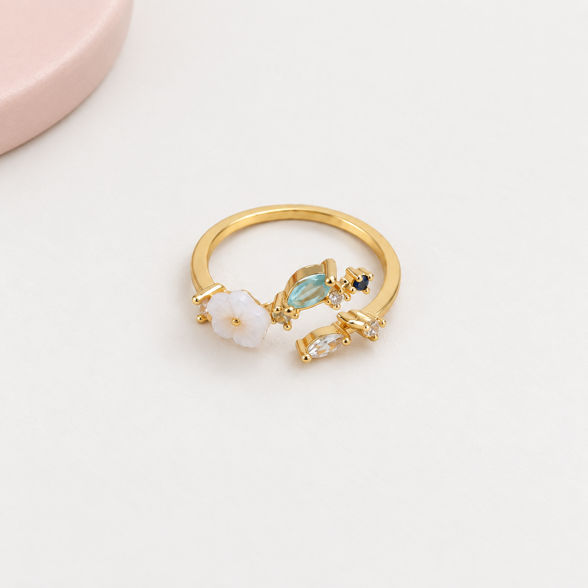 Magnolia flower adjustable ring with blue stones, front view