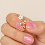 Magnolia flower adjustable ring shown close-up on a hand