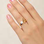 Magnolia flower adjustable ring worn on a hand
