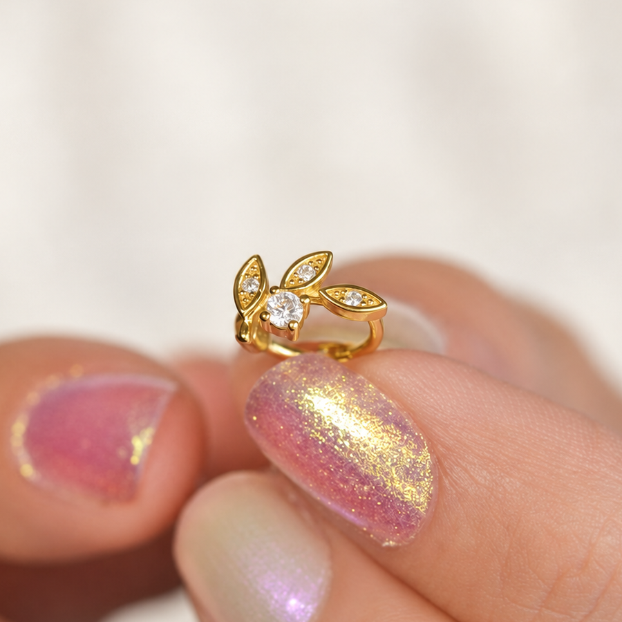 Gold crystal leaf hoop earring close-up