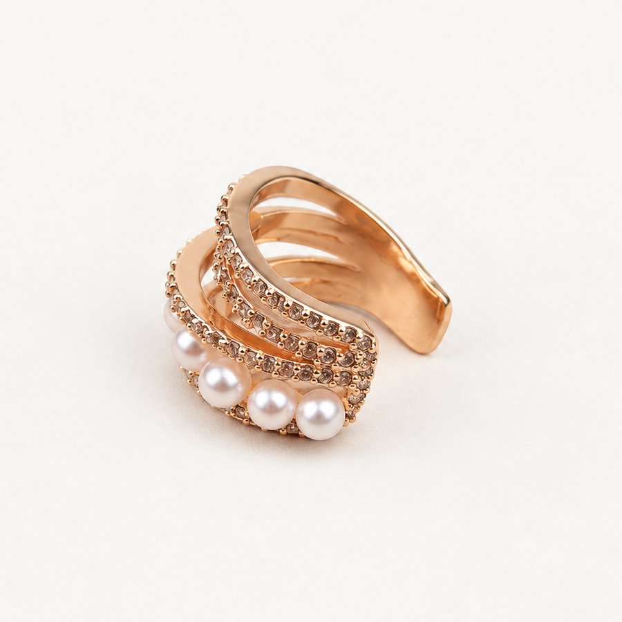 Angled front view of a gold-tone multi-row ear cuff with white pearl-like beads and clear stones.