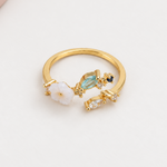 Magnolia flower adjustable ring with blue stones, front view