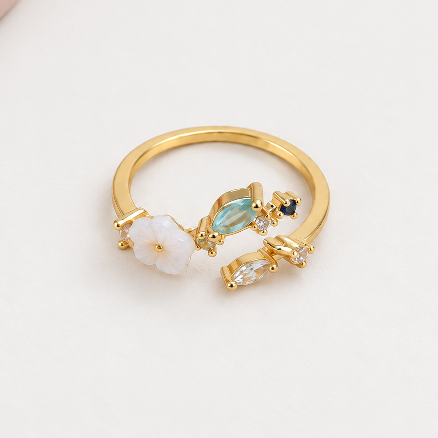 Magnolia flower adjustable ring with blue stones, front view