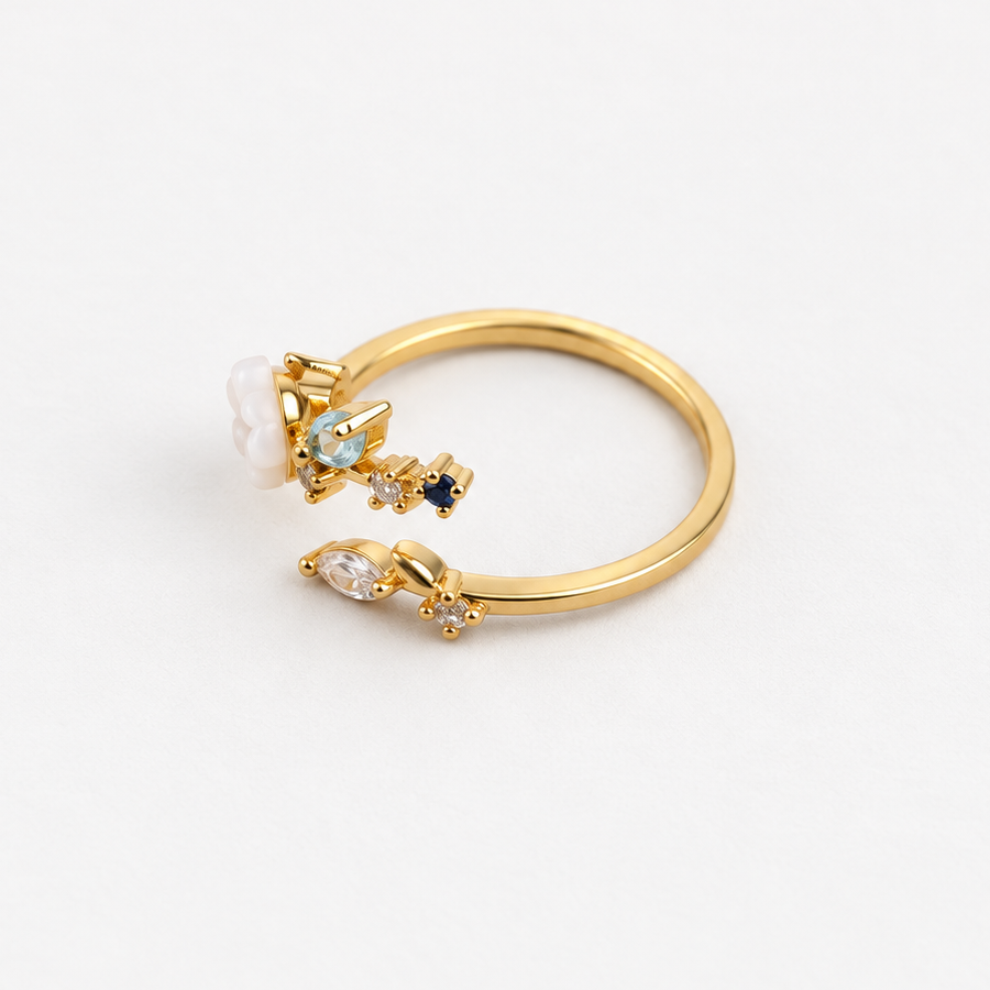 Magnolia flower adjustable ring with blue stones, angled view