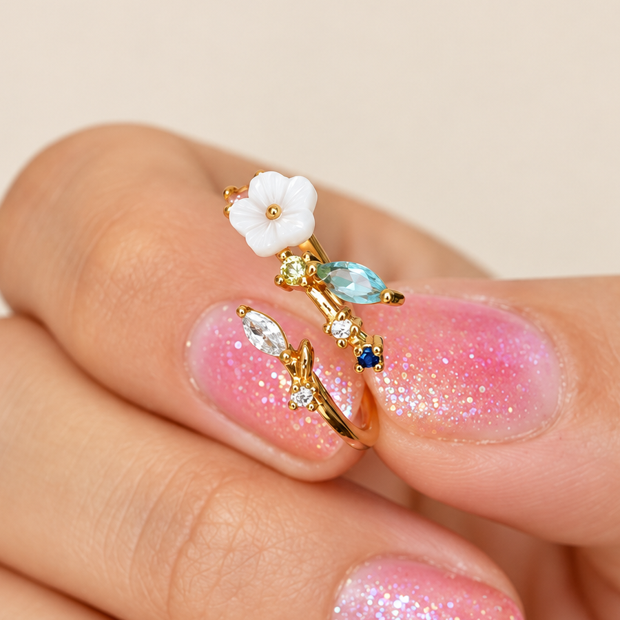 Magnolia flower adjustable ring shown close-up on a hand