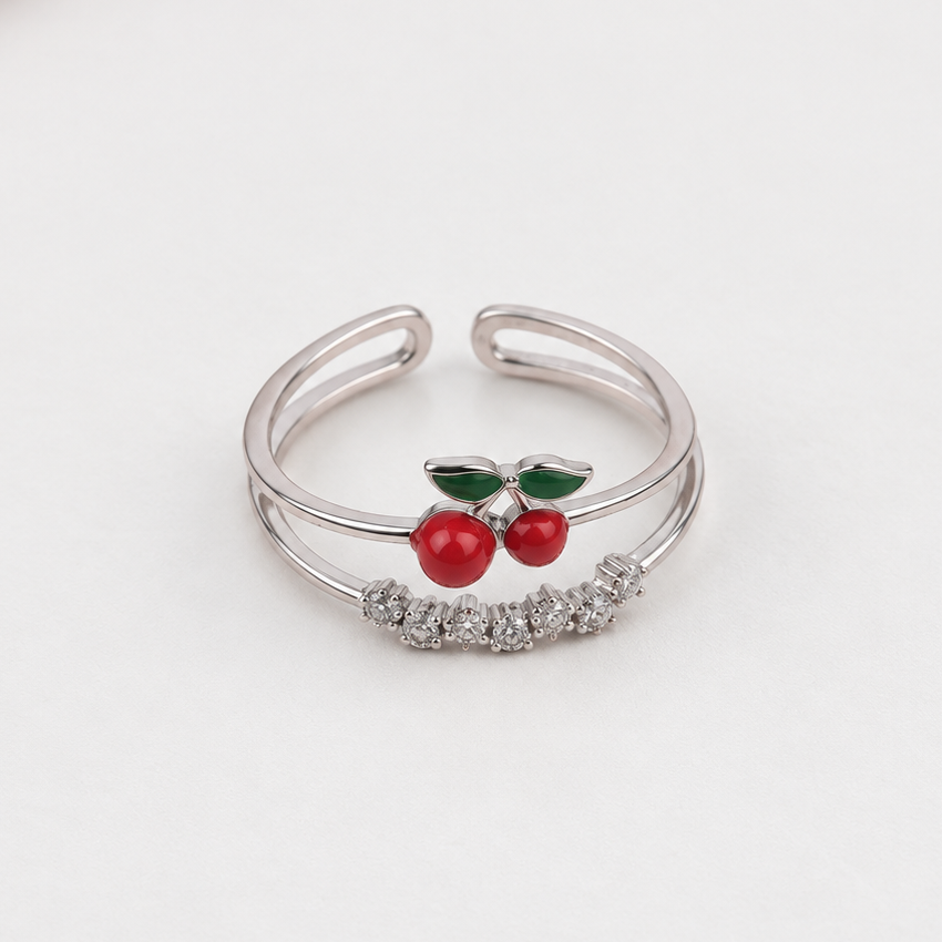 Silver-tone double-band cherry ring showing red fruit, green leaves, clear stones and an open back.