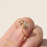 Gold-tone comet ear cuff with clear stones held between fingers, showing its star and curved tails.